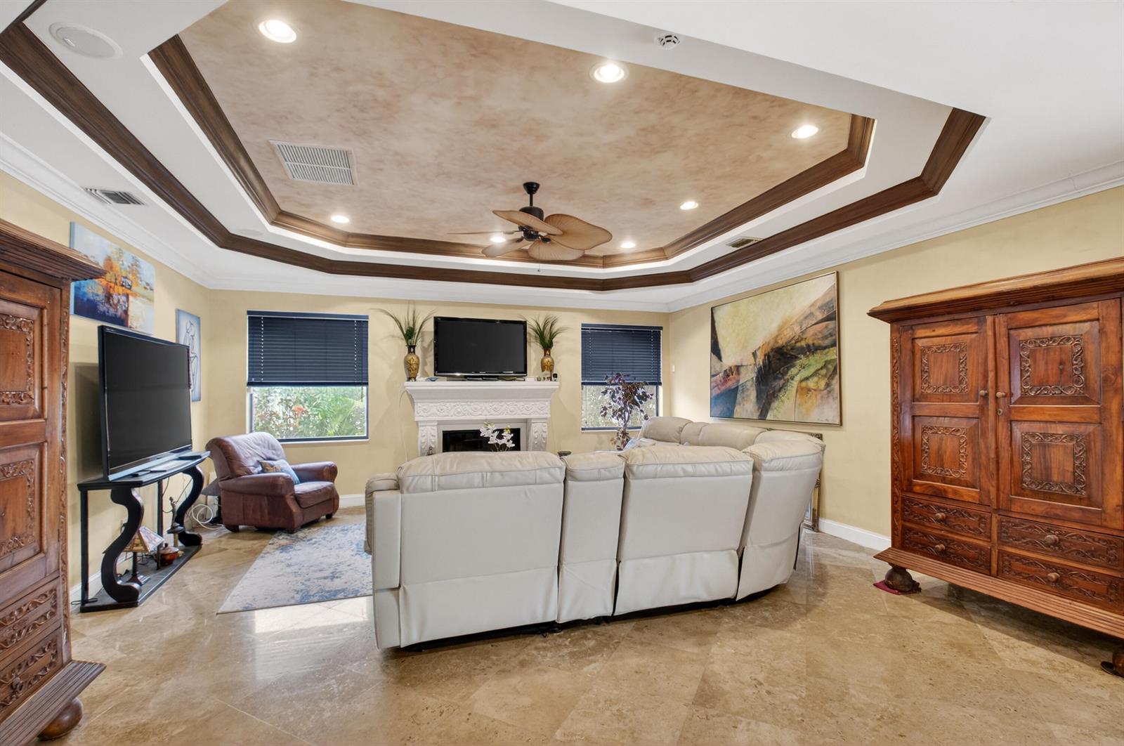 A living room features a tray ceiling, a fireplace, a white sectional, and tile flooring — 1940 SW 7th Place, Boca Raton FL 33486, BOCA RATON, FL