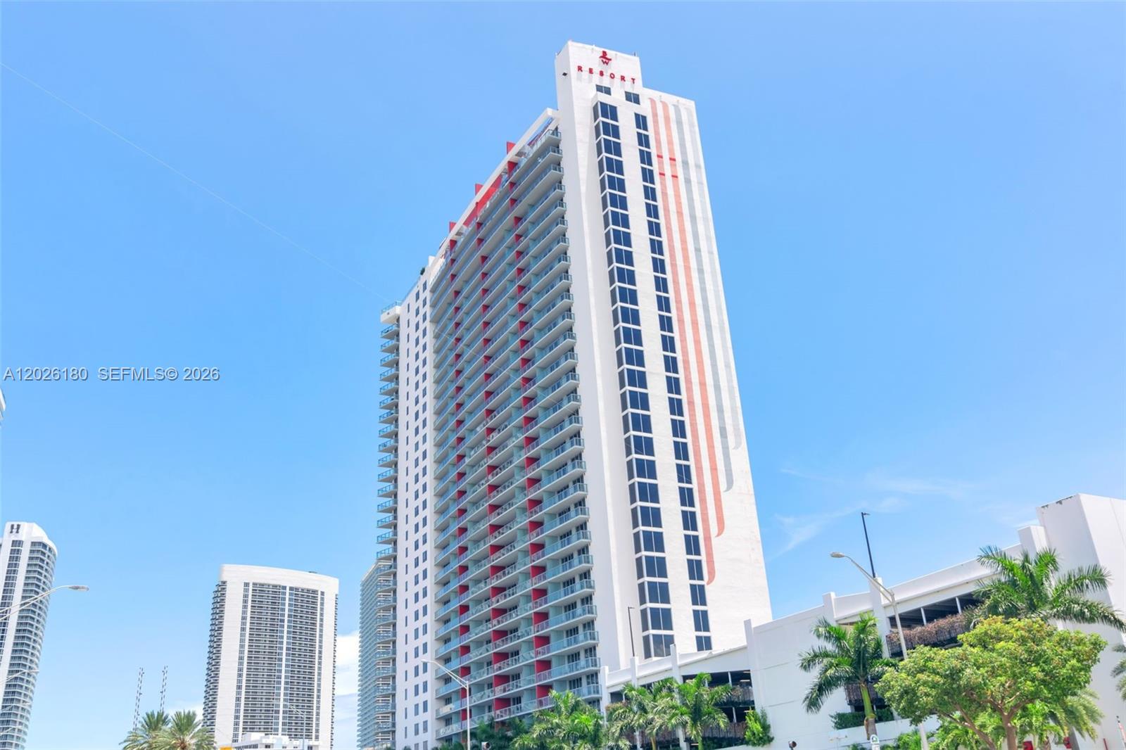 A tall, modern residential tower with balconies and a white facade stands against a sky — 2602 E E HALLADALE # T3105, Hallandale Beach FL 33009, HALLANDALE BEACH, FL