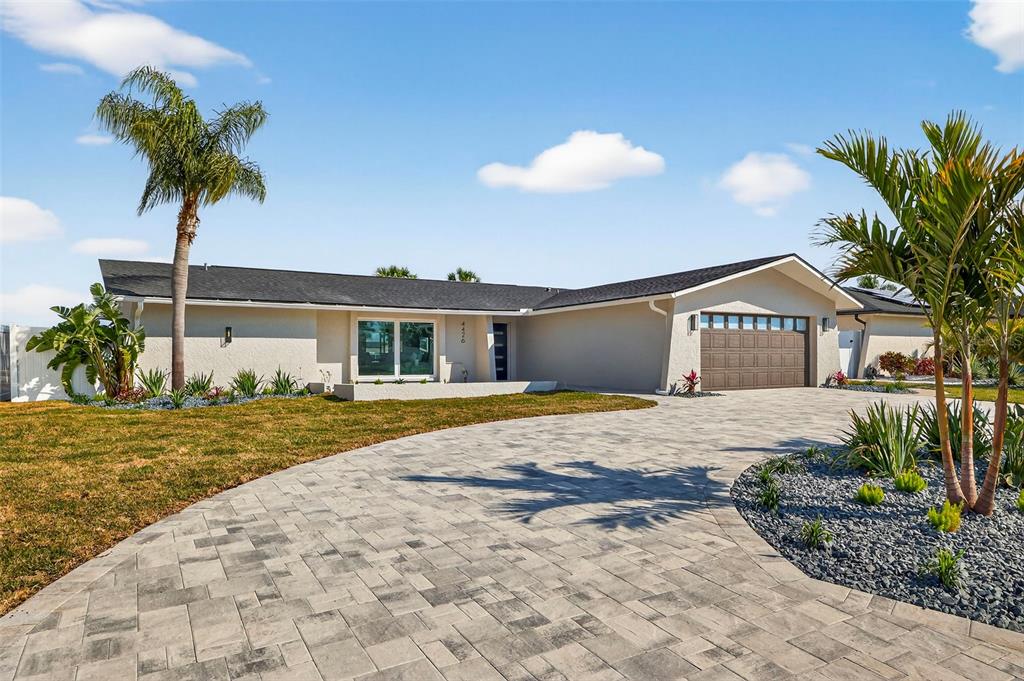 A single-story house with a paved driveway, palm trees, and a two-car garage — 4426 43RD STREET S, ST PETERSBURG, FL