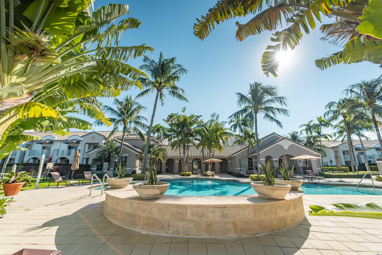 A wooden staircase leads through lush green foliage toward a sandy beach and the ocean — 3606 S Ocean Boulevard # 603, Highland Beach FL 33487, HIGHLAND BEACH, FL