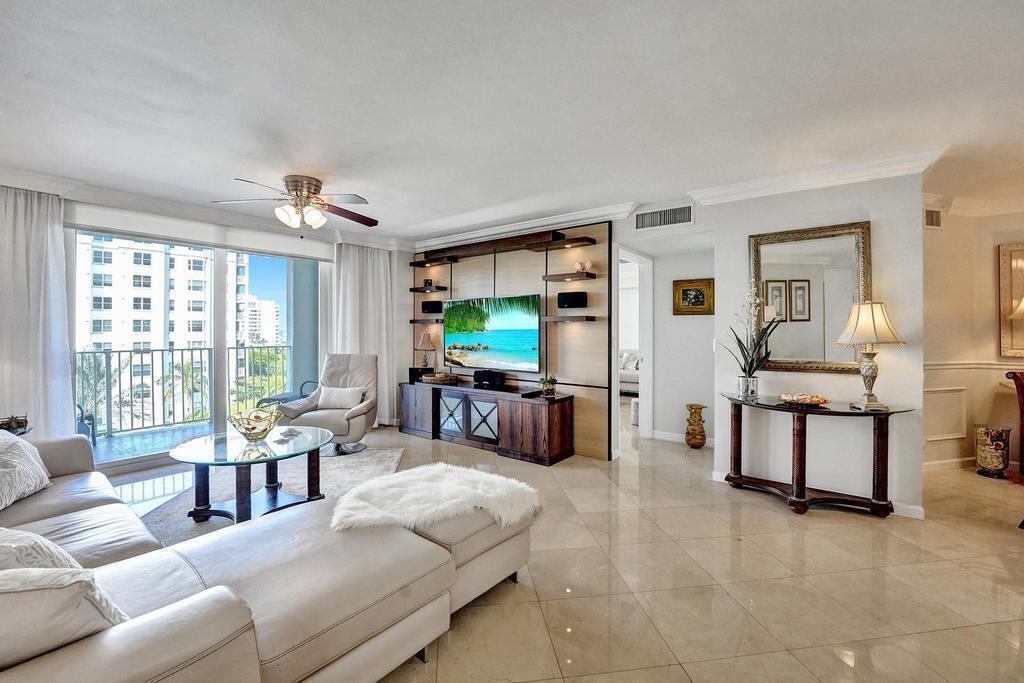 A kitchen features white upper cabinets, light wood lower cabinets, and a stone-topped breakfast bar — 3606 S Ocean Boulevard # 603, Highland Beach FL 33487, HIGHLAND BEACH, FL