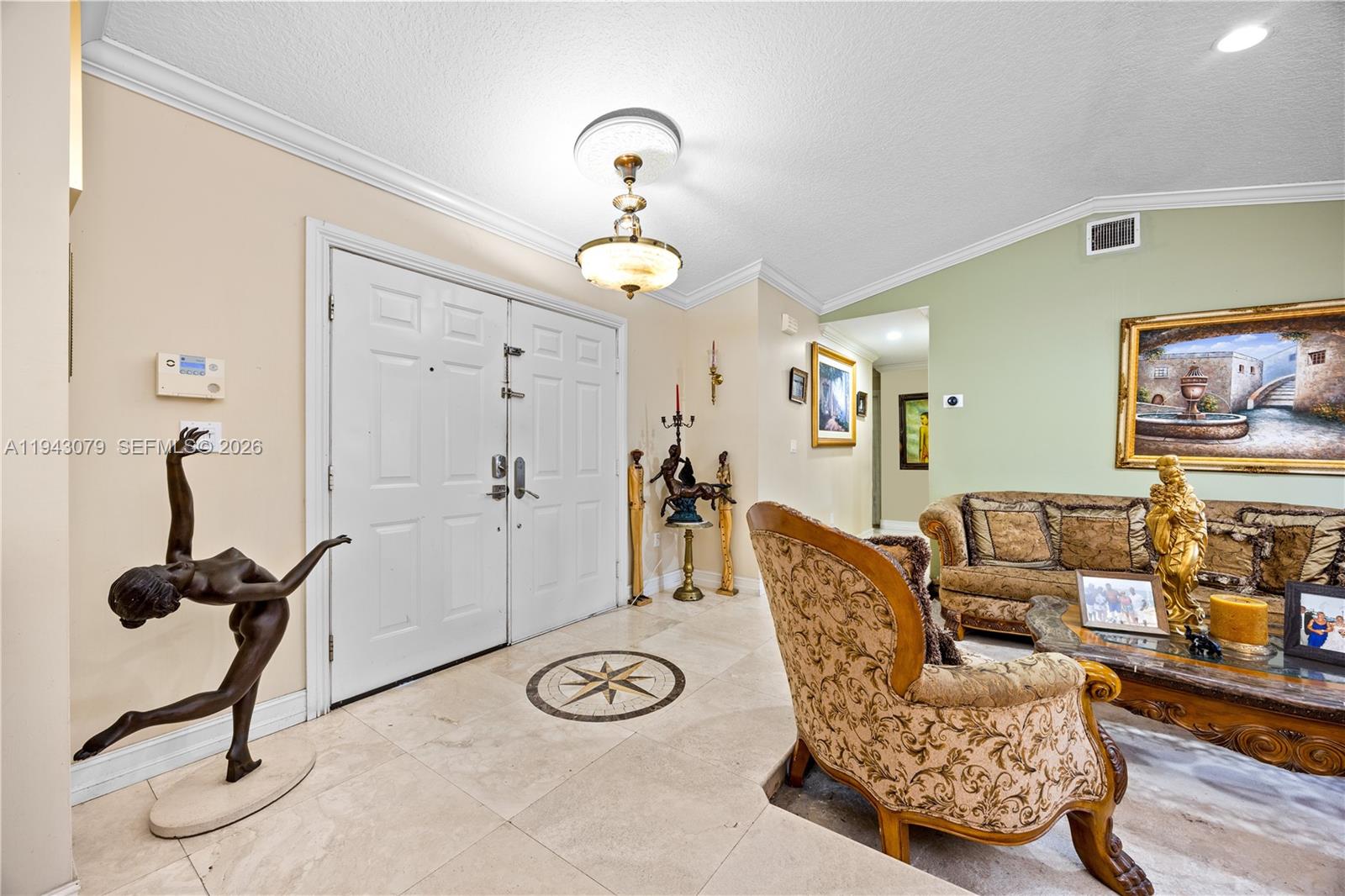 An entryway features a double door, tile flooring with an inlay, and a chandelier — 15330 SW 170th Ter, Miami FL 33187, MIAMI, FL
