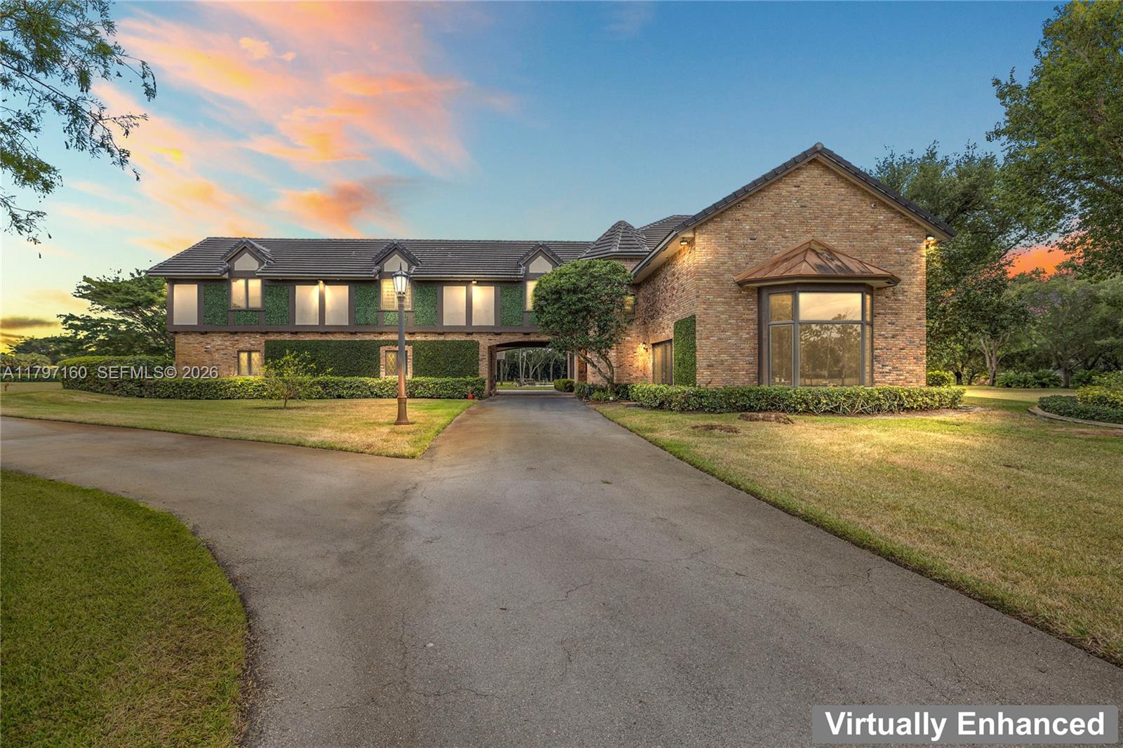 A two-story brick house with a driveway passing through a central archway — 8700 Surrey Ln, Boca Raton FL 33496, BOCA RATON, FL