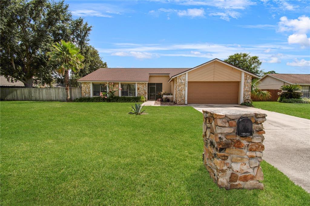 A single-story house with a stone facade, a brown roof, and a stone mailbox — 8628 GRANADA BOULEVARD, ORLANDO, FL