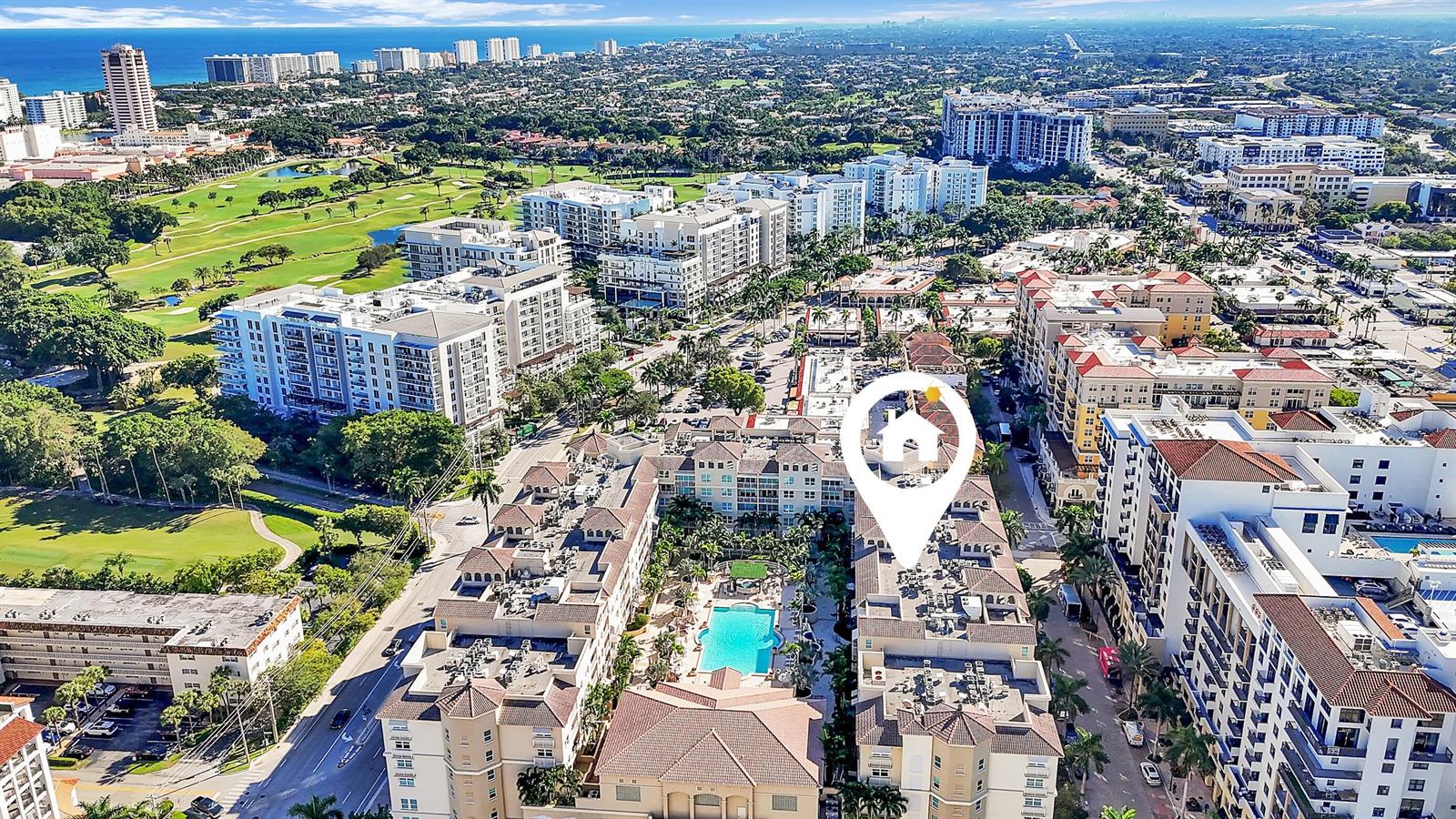An aerial view shows a multi-story residential complex with a central pool and surrounding city — 99 SE Mizner Boulevard # 40, Boca Raton FL 33432, BOCA RATON, FL