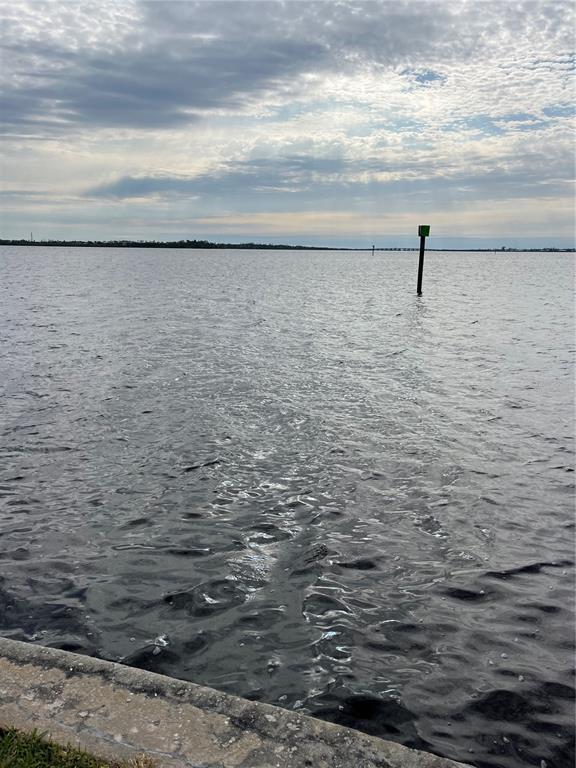 A view of a body of water with a green navigational marker under a cloudy sky — 12437 RAN TERRACE, PORT CHARLOTTE, FL