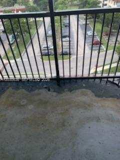 A view from a balcony looking down at a parking lot through a metal railing — 4174 Inverrary Dr # 911, Lauderhill FL 33319, LAUDERHILL, FL