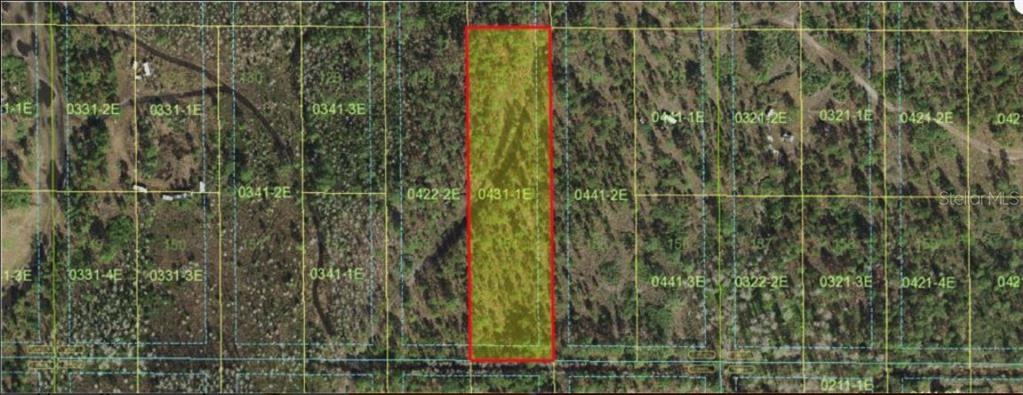 This is an aerial map view showing a rectangular parcel of land highlighted in yellow — HOLOPAW GROVES ROAD, ST CLOUD, FL