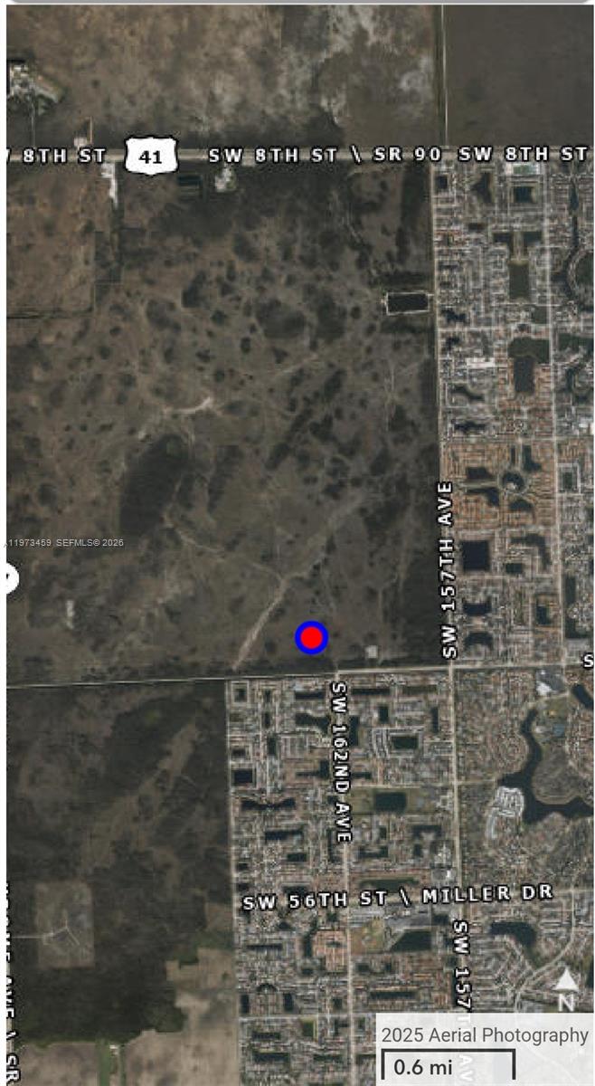 This is an aerial map showing a vacant lot marked with a blue circle — 42 sw 162ave, Miami FL 33185, MIAMI, FL