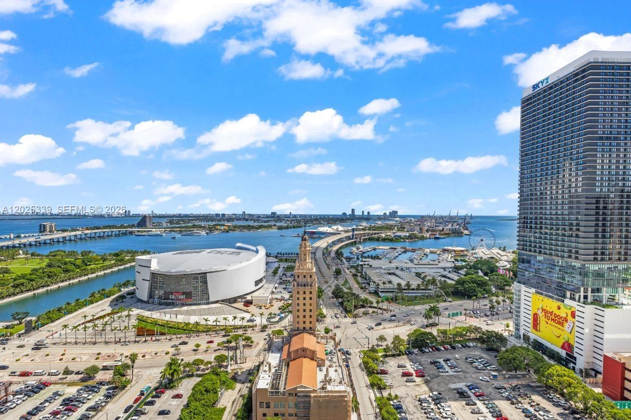 An aerial view of downtown Miami featuring the Kaseya Center, Freedom Tower, and surrounding waterfront — MIAMI, FL