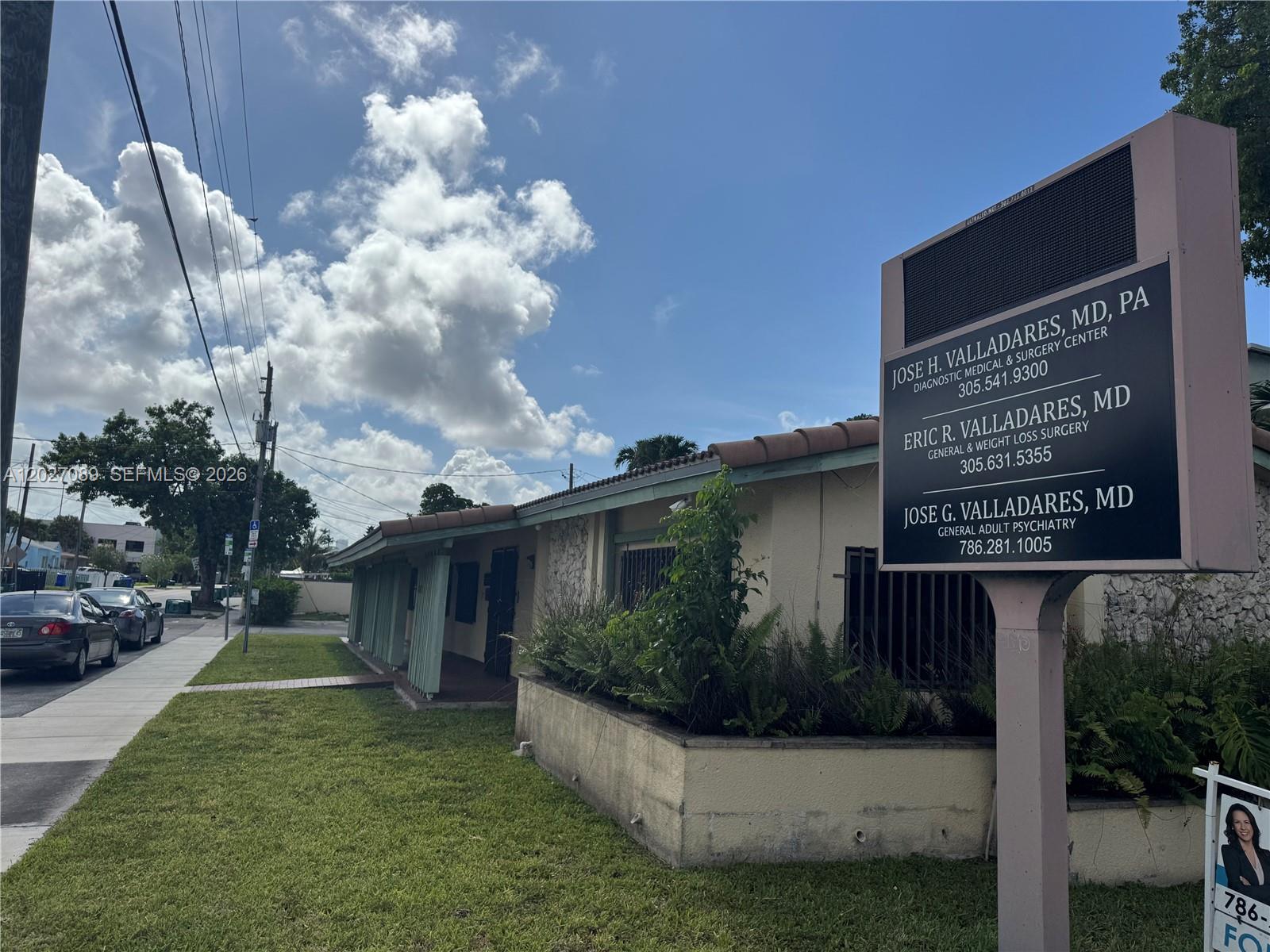 A medical office building exterior features a prominent sign listing three doctors and their specialties — 2660 SW 3rd St, Miami FL 33135, MIAMI, FL