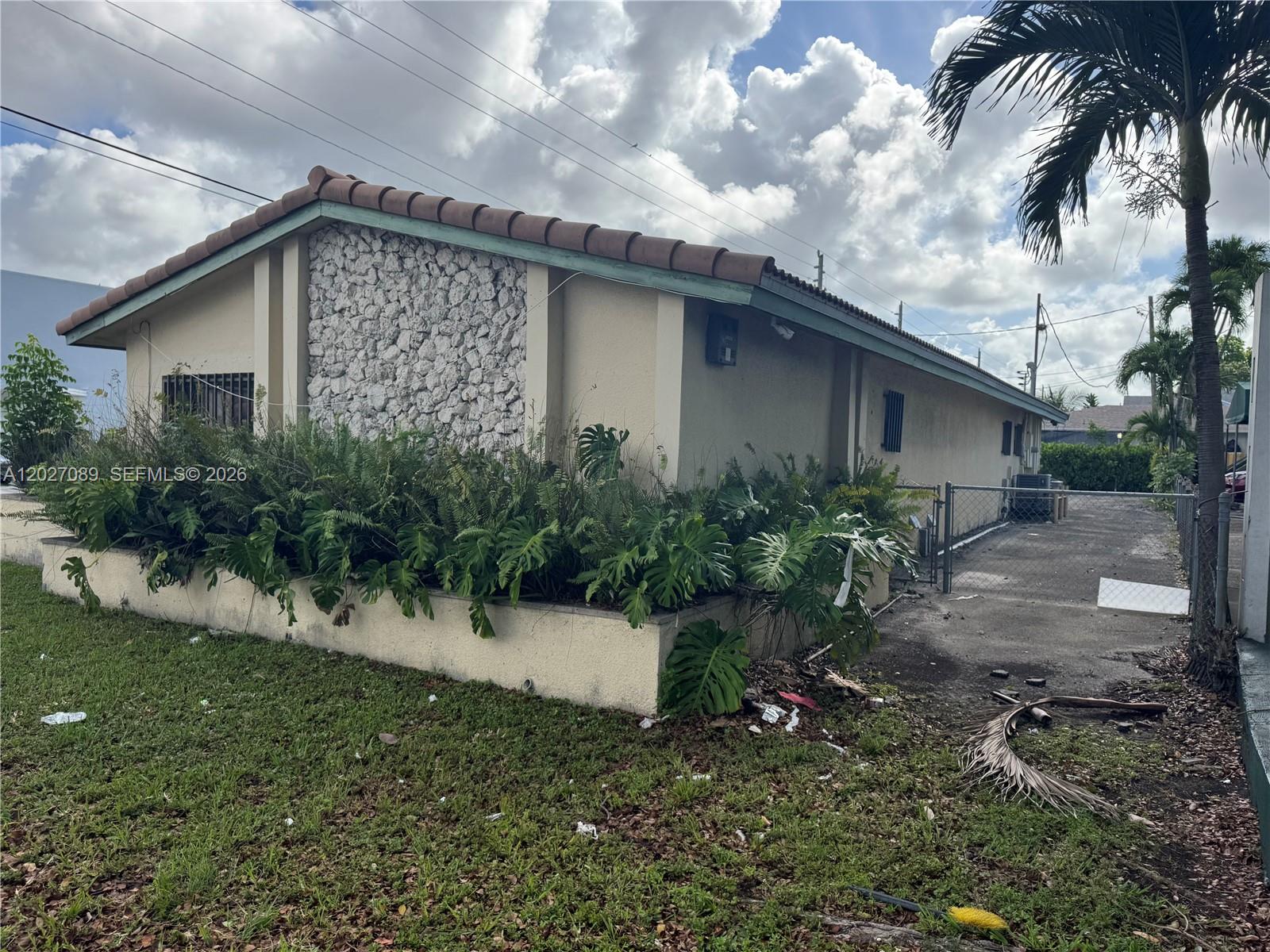 A single-story building features a stone facade, a tiled roof, and a large planter box — 2660 SW 3rd St, Miami FL 33135, MIAMI, FL