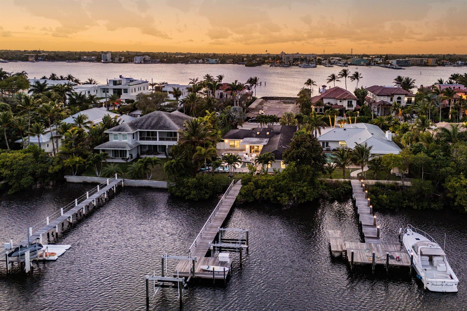 An aerial view of a waterfront house with a pool and a red arrow pointing down — 820 N Atlantic Drive, Lantana FL 33462, LANTANA, FL