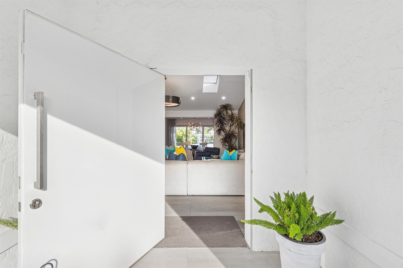 A patio with a fire pit, white chairs, and a pool overlooking a waterfront building — 820 N Atlantic Drive, Lantana FL 33462, LANTANA, FL