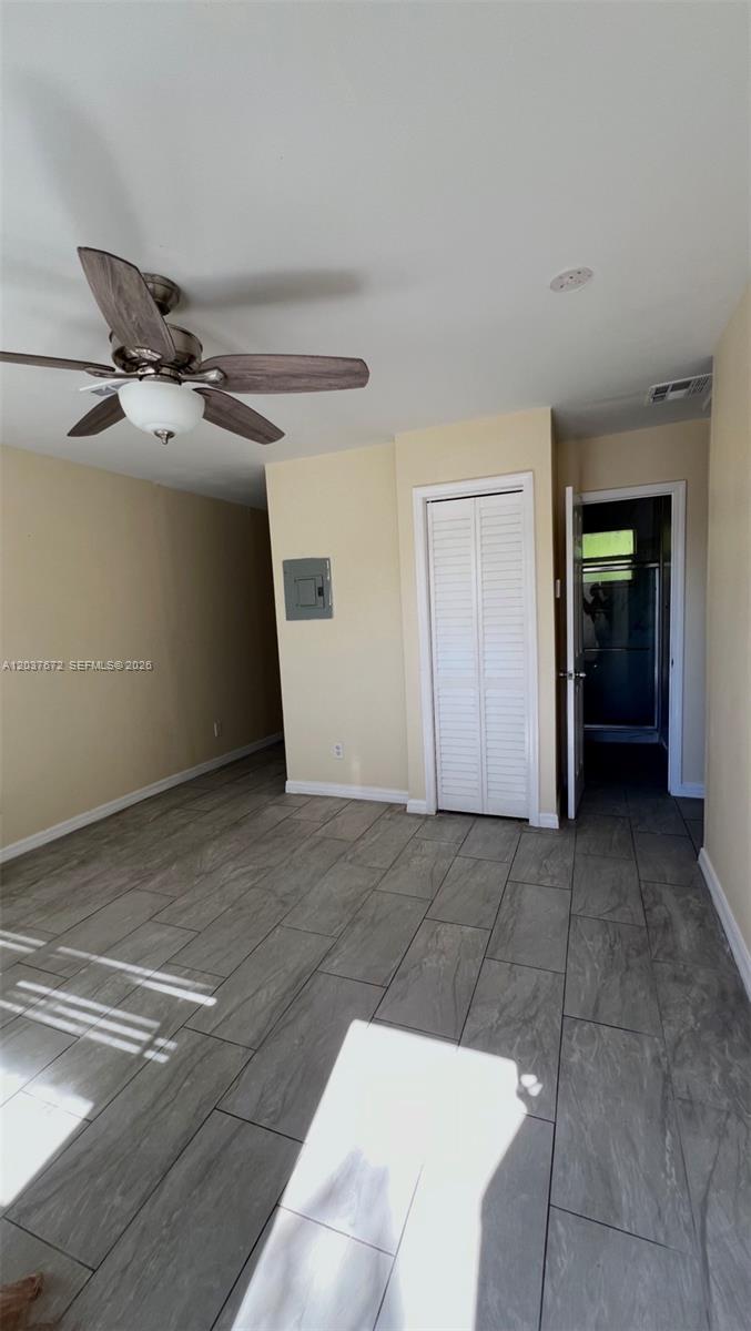 A room with light-colored walls, gray tile flooring, a ceiling fan, and a closet — 706 SW 4th Ter # 4, Dania Beach FL 33004, DANIA BEACH, FL