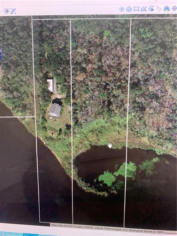This aerial map shows a residential property with a house and outbuilding along a lake — 1061 ENTERPRISE OSTEEN ROAD, DELTONA, FL