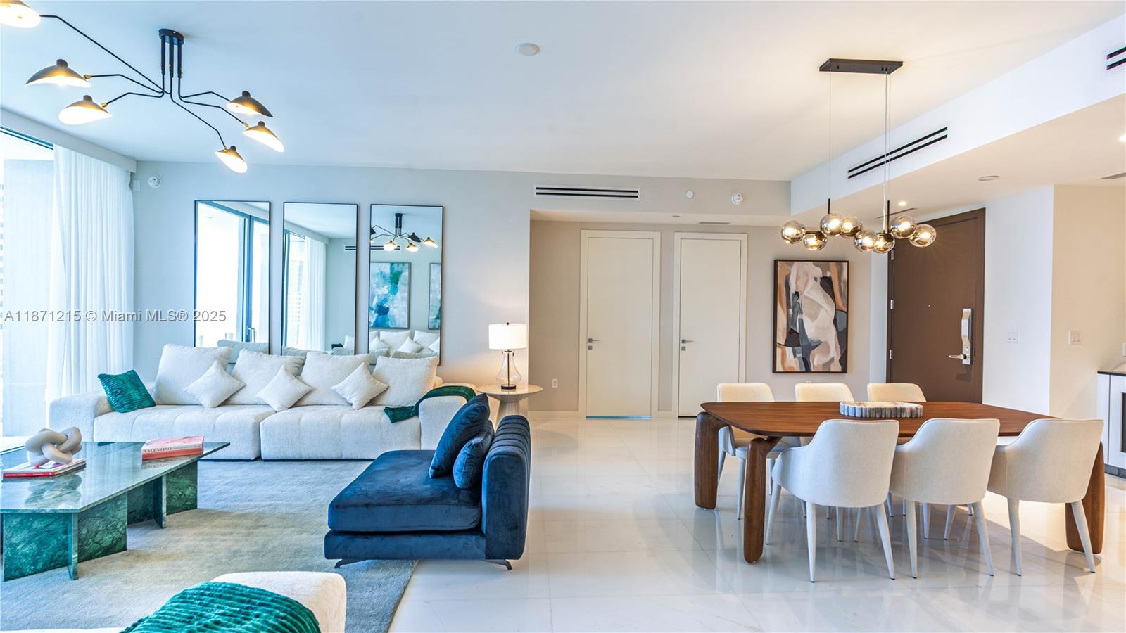 A modern living and dining area features white tile floors, neutral furniture, and contemporary lighting — 300 Biscayne Blvd Way # 503C, Miami FL 33131, MIAMI, FL