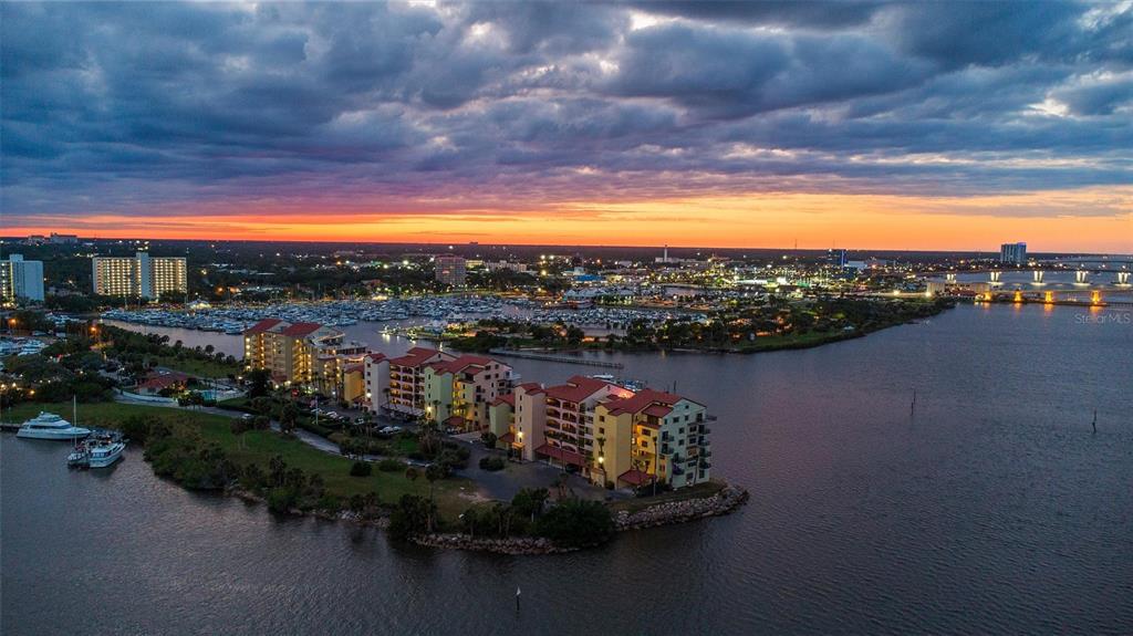An aerial view of waterfront apartment buildings and a marina at sunset — 744 MARINA POINT DRIVE UNIT 7440, DAYTONA BEACH, FL