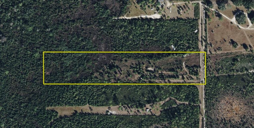 An aerial map view shows a rectangular plot of land outlined in yellow along a road — 22370 NE 130TH AVENUE, FORT MC COY, FL