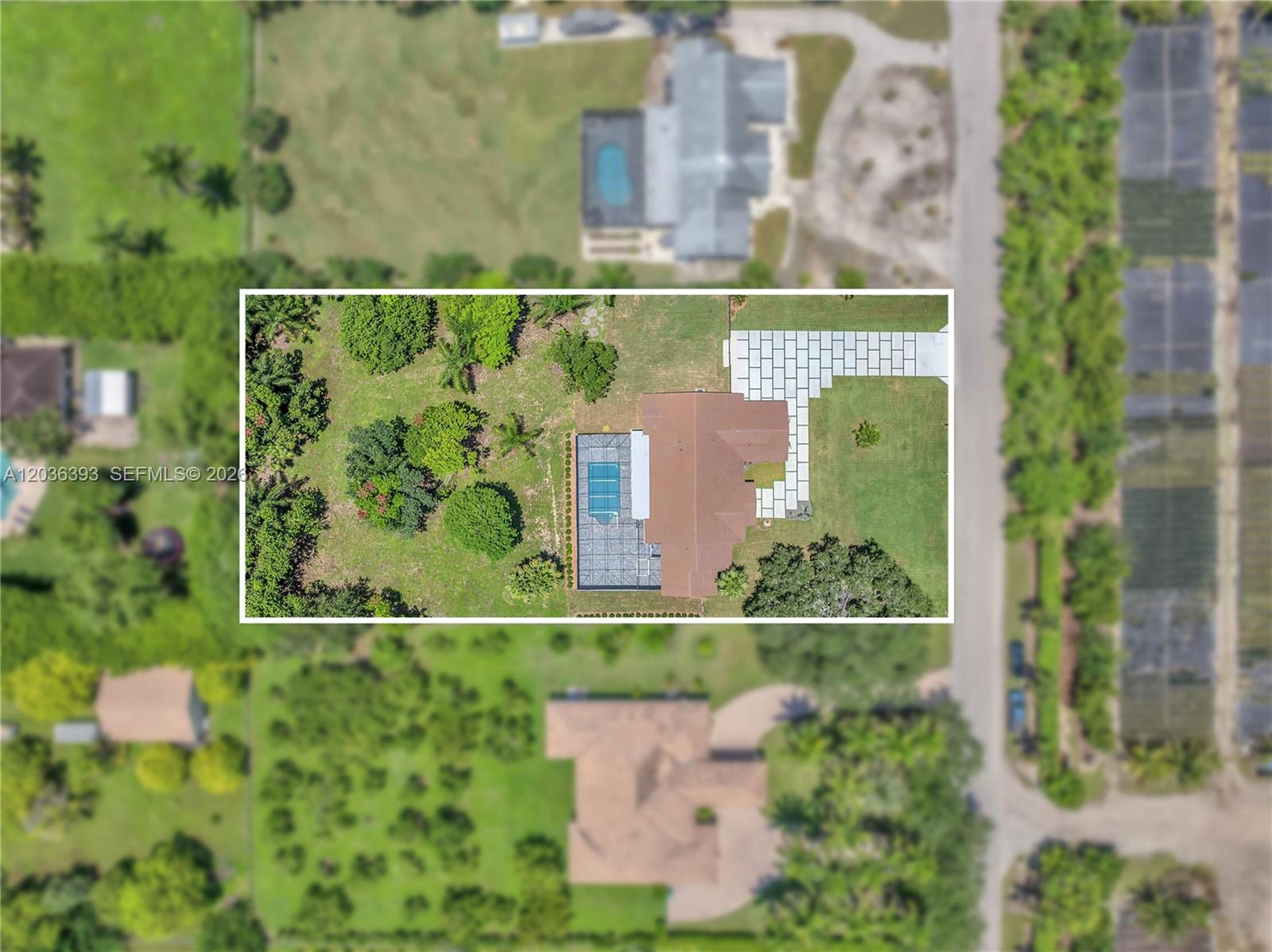 This aerial view shows a house with a screened pool and a paved driveway — 16100 SW 252nd St, Homestead FL 33031, HOMESTEAD, FL