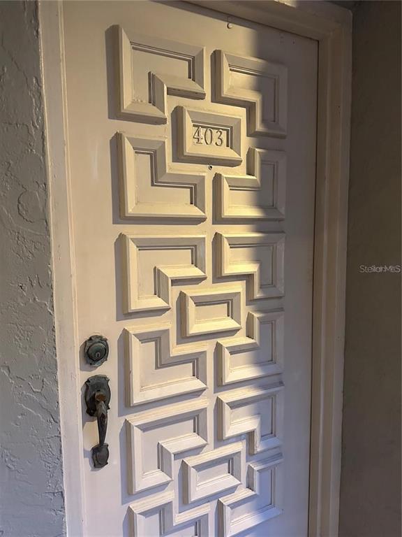 A white door with a geometric panel design and the number 403 attached — 500 N OSCEOLA AVENUE UNIT 403, CLEARWATER, FL