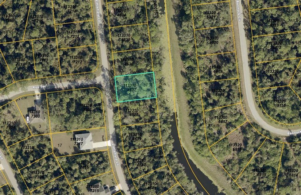 This is an aerial map showing a highlighted vacant lot among surrounding wooded residential properties — LITTLEFIELD LANE, NORTH PORT, FL