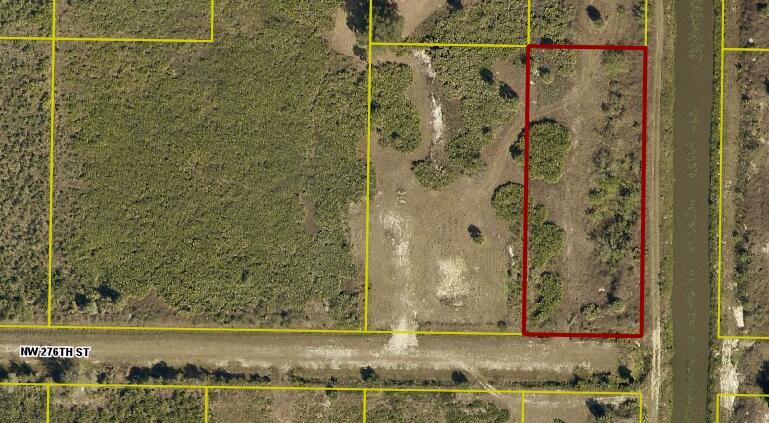 An aerial view shows a rectangular plot of land outlined in red near a canal — 0000 NW 276 Street, Okeechobee FL 34972, OKEECHOBEE, FL
