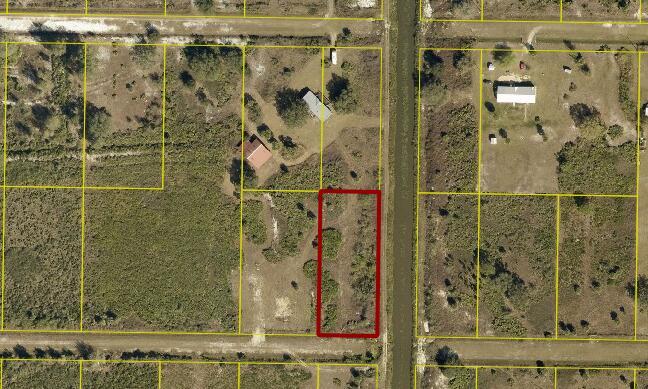 An aerial view shows a rectangular vacant lot outlined in red next to a canal — 0000 NW 276 Street, Okeechobee FL 34972, OKEECHOBEE, FL