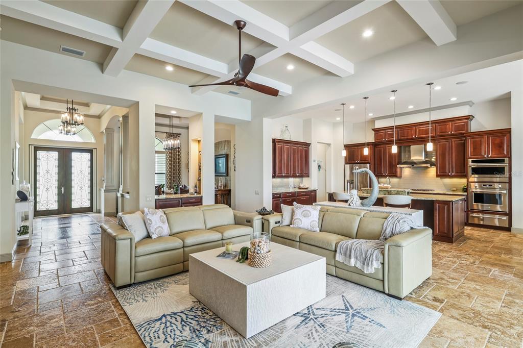 A single-story house with a tiled roof, three-car garage, and a paved driveway — 1355 GREBE DRIVE, PUNTA GORDA, FL