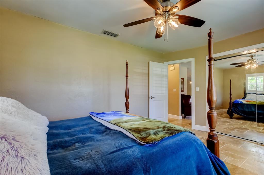 A bedroom features a four-poster bed, a ceiling fan, and mirrored closet doors — 4174 14TH LANE NE, ST PETERSBURG, FL