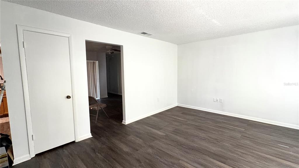 A kitchen features wood cabinets, a stainless steel refrigerator, a double sink, and laminate countertops — 2262 MENOMONEE COURT, ORLANDO, FL