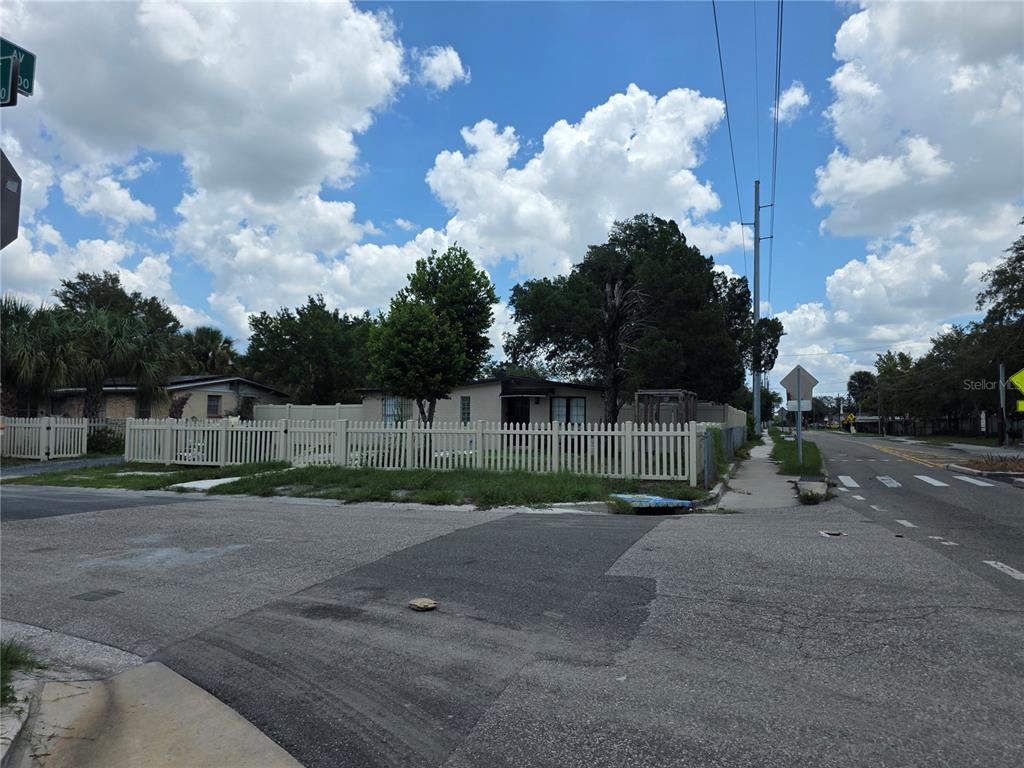 A single-story house with a white picket fence sits on a corner lot — 3001 N 45TH STREET, TAMPA, FL