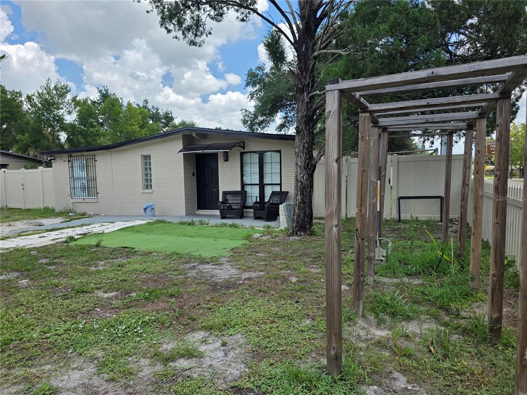 A single-story brick house with a wooden pergola in the front yard — 3001 N 45TH STREET, TAMPA, FL