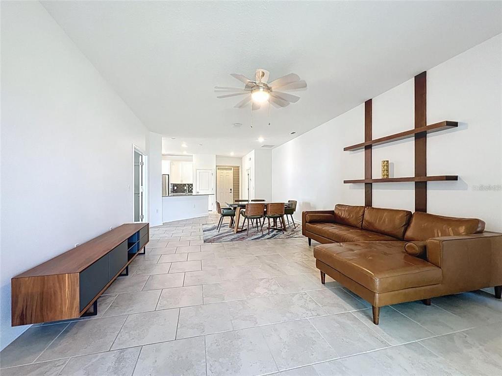 A bedroom features a wooden bed frame, a white dresser with a television, and a ceiling fan — 195 PRESTON AVE, DAVENPORT, FL