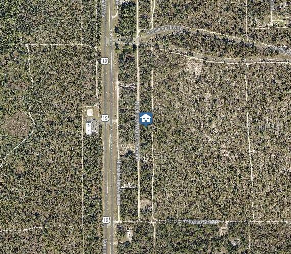 This is an aerial map view showing a residential lot in a wooded area — LOT 8 NECKLACE WARBLER AVENUE, WEEKI WACHEE, FL