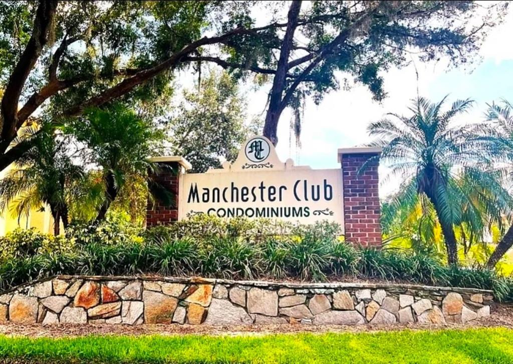 A stone and brick monument sign identifies the Manchester Club Condominiums under large trees — 4358 S LAKE ORLANDO PARKWAY UNIT 3-3, ORLANDO, FL