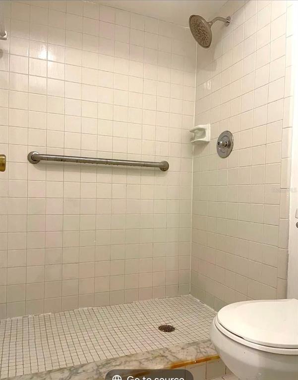 A walk-in shower with white square tiles, a grab bar, and a showerhead — 4358 S LAKE ORLANDO PARKWAY UNIT 3-3, ORLANDO, FL