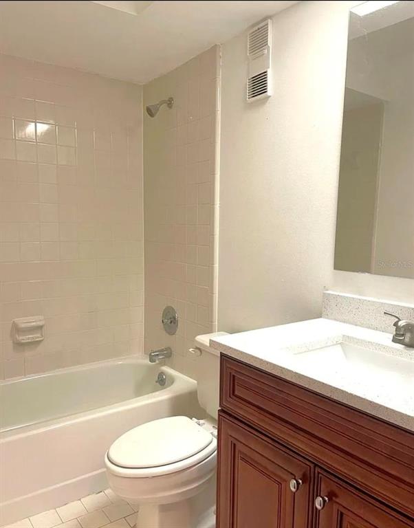A bathroom features a white bathtub, a toilet, and a vanity with a stone countertop — 4358 S LAKE ORLANDO PARKWAY UNIT 3-3, ORLANDO, FL