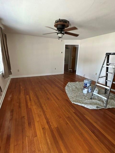 An empty room features hardwood floors, a ceiling fan, and a ladder on a drop cloth — 248 S CLAYTON STREET, MOUNT DORA, FL