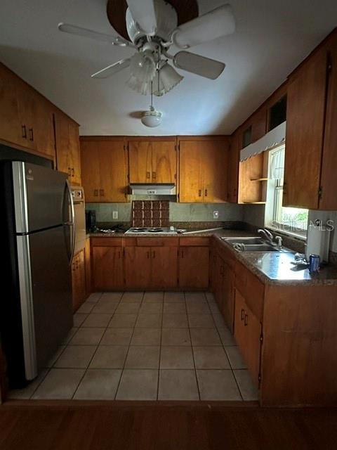A kitchen features wood cabinets, a stainless steel refrigerator, and a ceiling fan — 248 S CLAYTON STREET, MOUNT DORA, FL