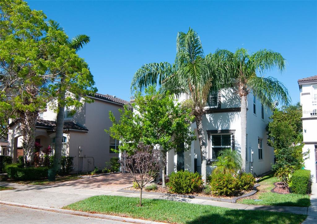 A two-story white house with palm trees and a paved driveway under a clear sky — 5124 SW 155TH AVENUE, MIRAMAR, FL