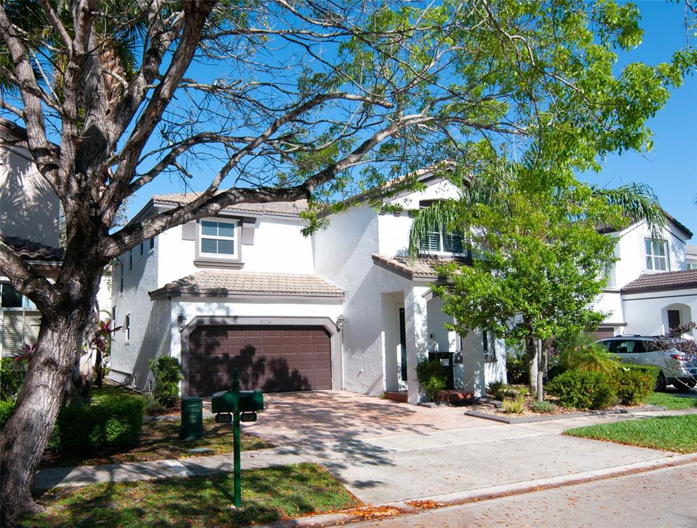 A two-story white stucco house with a brown garage and a paved driveway — 5124 SW 155TH AVENUE, MIRAMAR, FL