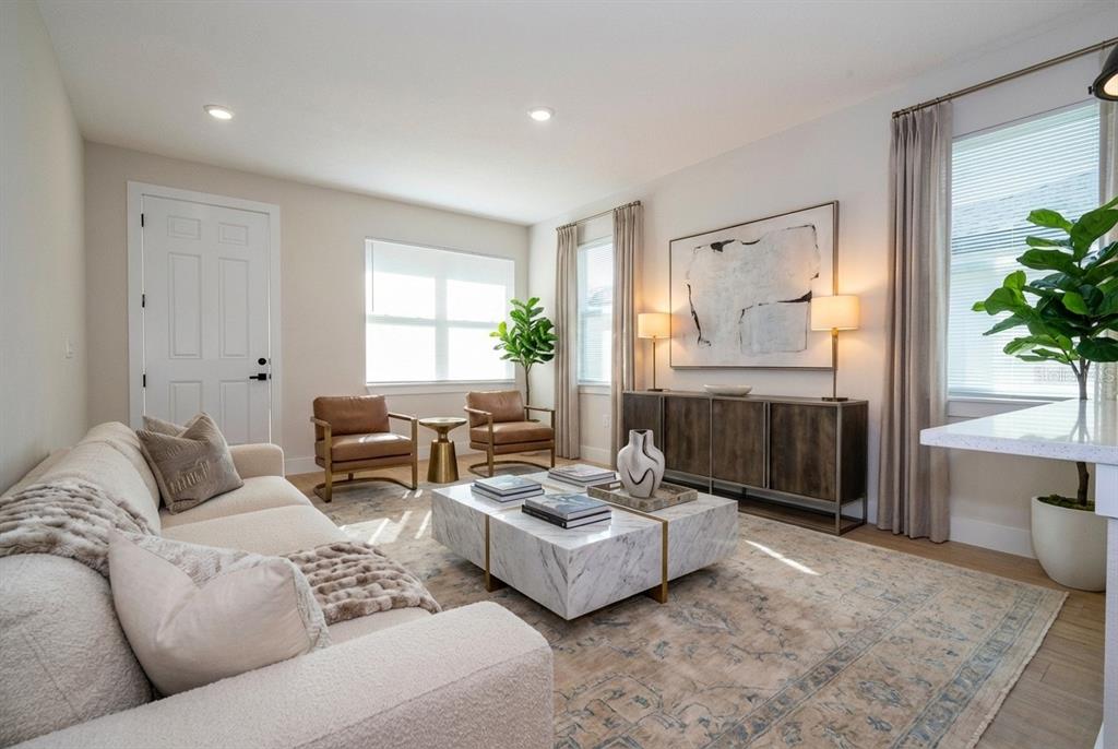 A living room features a white sofa, marble coffee table, leather chairs, and a sideboard — 3449 W JEFFERSON STREET, ORLANDO, FL