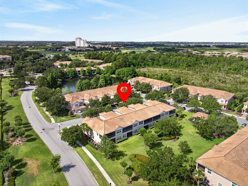 An aerial view shows a multi-unit residential building with a red location pin — 8311 FOSTER DRIVE, DAVENPORT, FL
