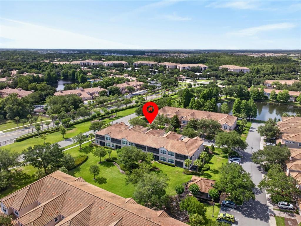 An aerial view shows a multi-story residential building with a red pin marking the location — 8311 FOSTER DRIVE, DAVENPORT, FL