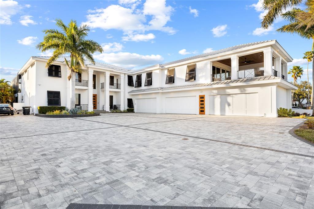 A large white two-story house features a spacious paved driveway and multiple garage doors — 951 S BAYSHORE BOULEVARD, SAFETY HARBOR, FL