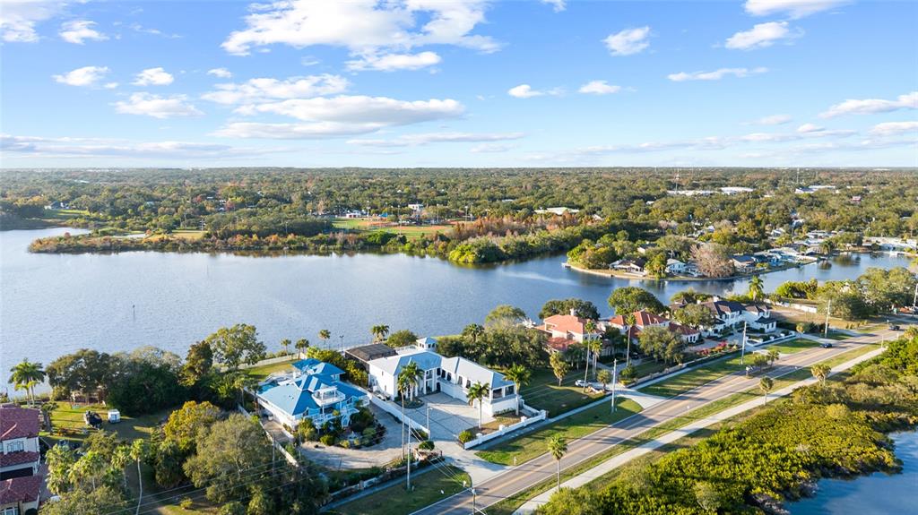 An aerial view shows waterfront homes along a road with a lake in the background — 951 S BAYSHORE BOULEVARD, SAFETY HARBOR, FL