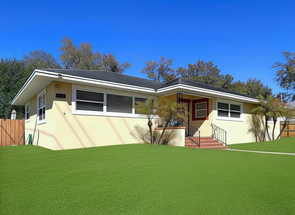 A swimming pool sits inside a screened-in patio area behind a yellow house — 717 W END CRESCENT N, LAKELAND, FL