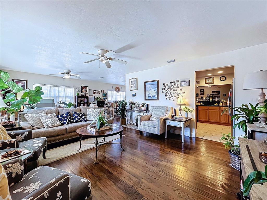 An aerial view shows a single-story house with a hip roof and a front porch — 717 W END CRESCENT N, LAKELAND, FL