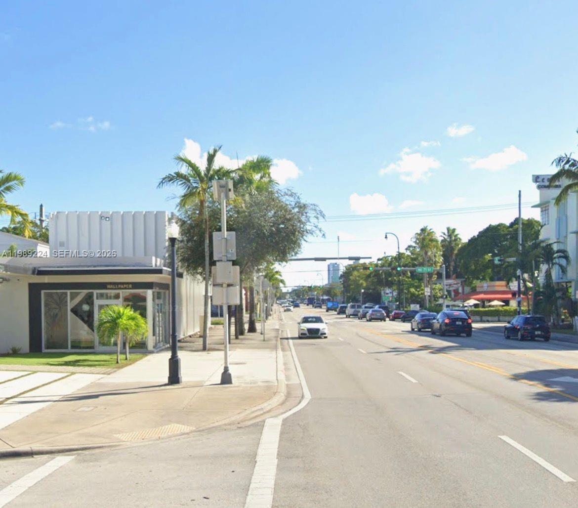A street-level view shows a white commercial building with a storefront next to a road — 7111 Biscayne Blvd, Miami FL 33138, MIAMI, FL